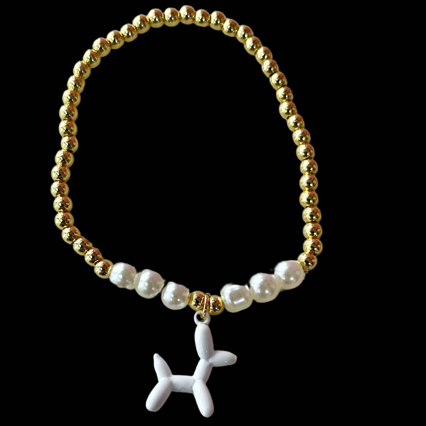 gold and white pearl band bracelet with a white balloon shaped dog