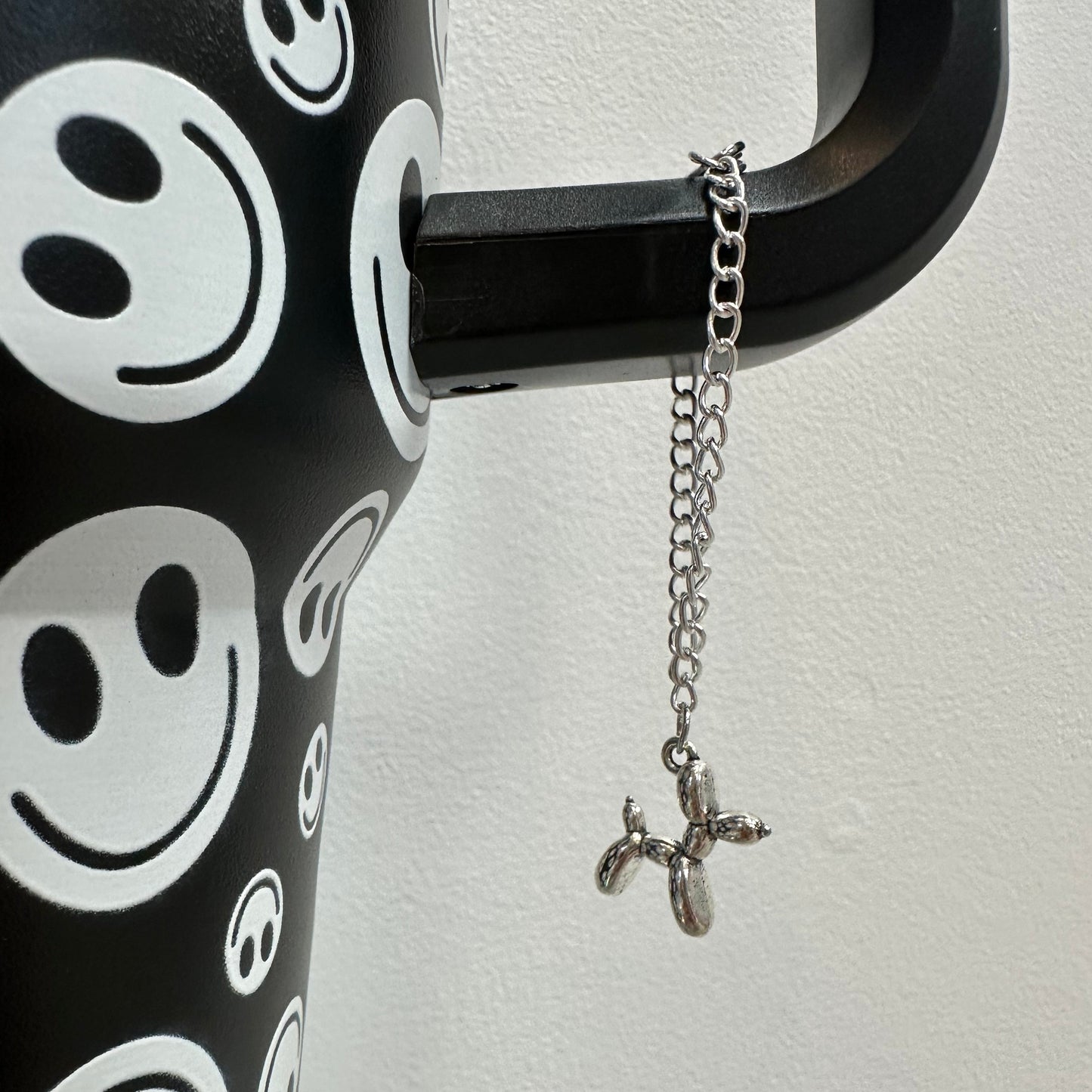 picture of a balloon shaped dog hanging from a chain on a tumbler